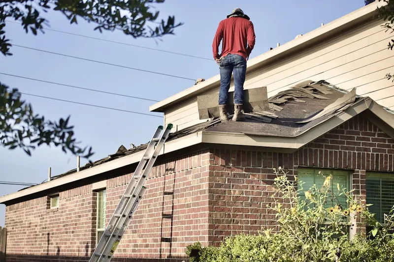 Professional roofer working on a residential roof in Fort Atkinson